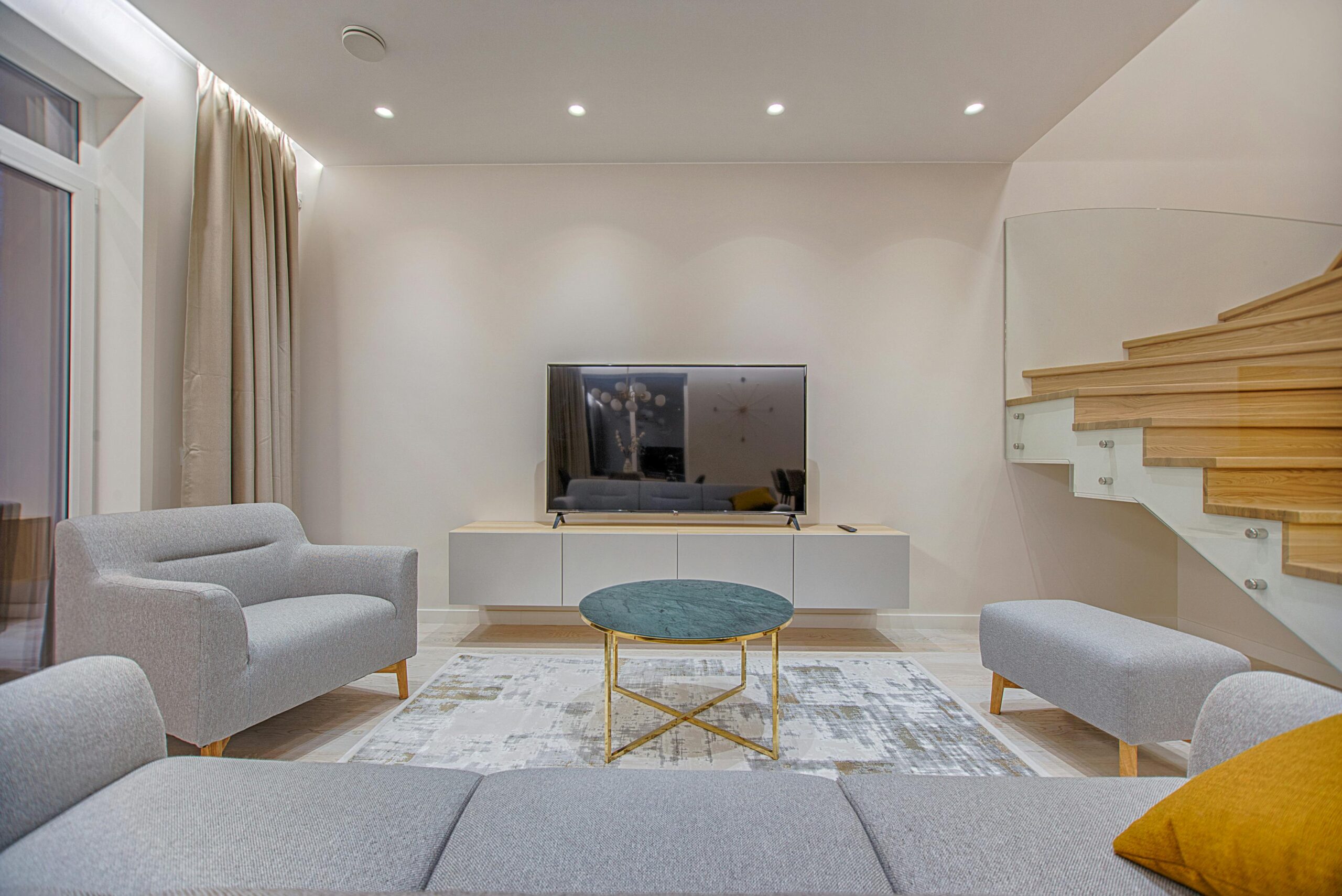 Stylish minimalist living room with modern furniture and warm lighting.